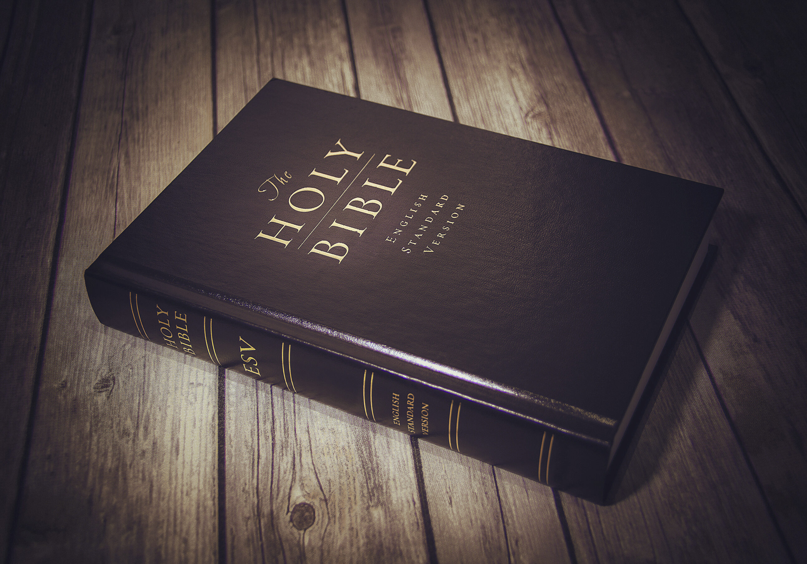 The Holy Bible on a wooden table.